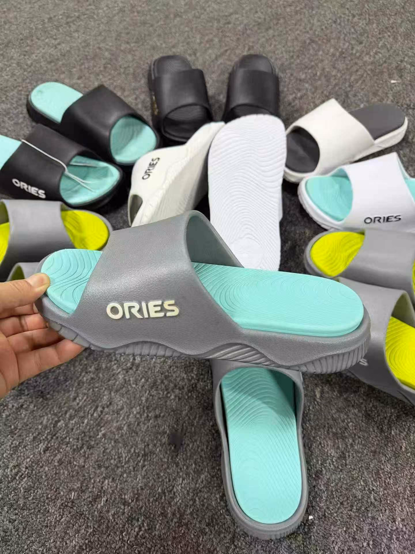 Close-up of the ergonomic footbed texture and anti-skid grip tread on men slides