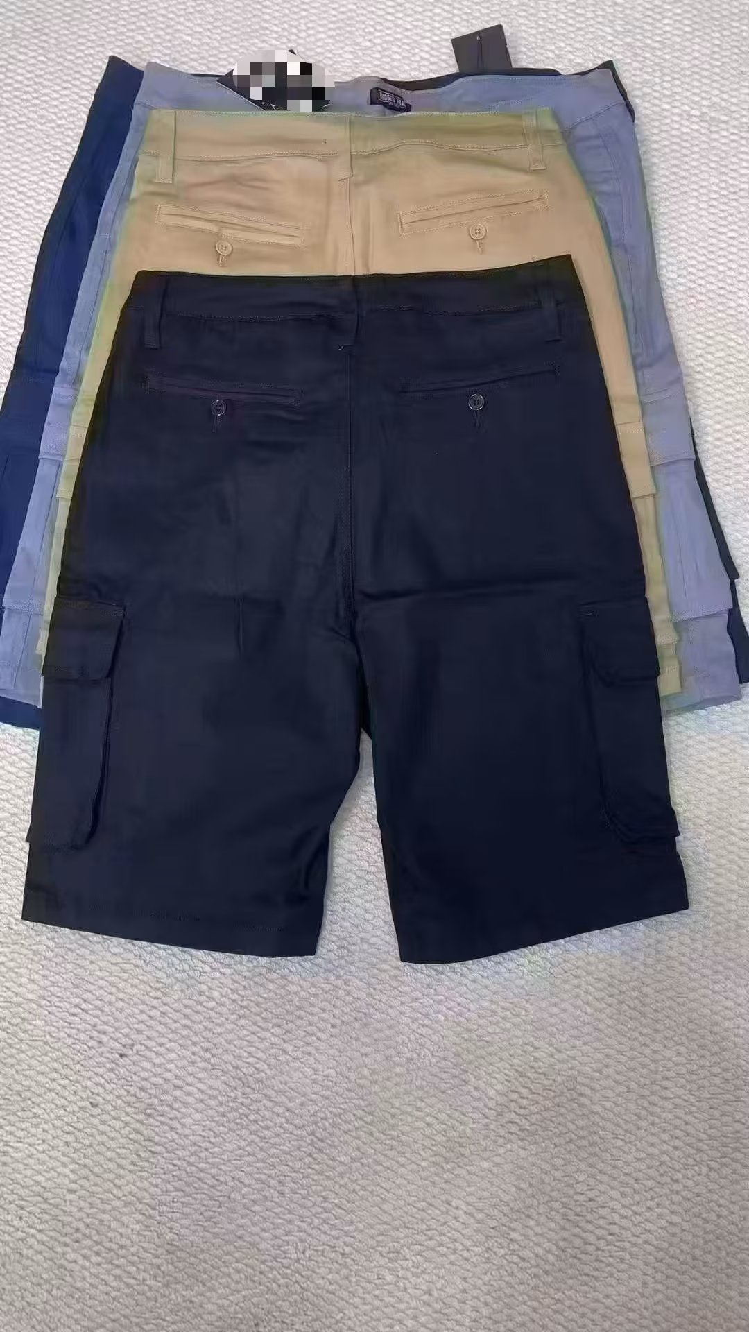 Back view of rugged men's utility shorts showcasing symmetrical rear welt pockets and heavy-duty double-stitched belt loops