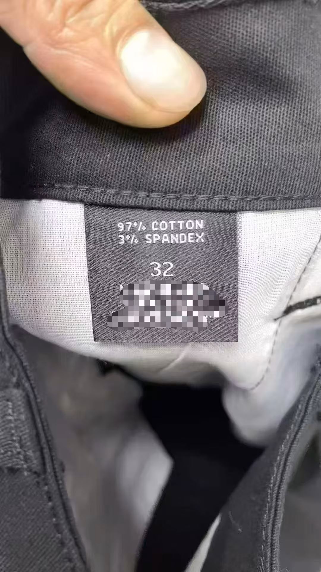 Garment laundering instructions and heavy cotton-blend stretch fabric care label sewn inside men's tactical shorts