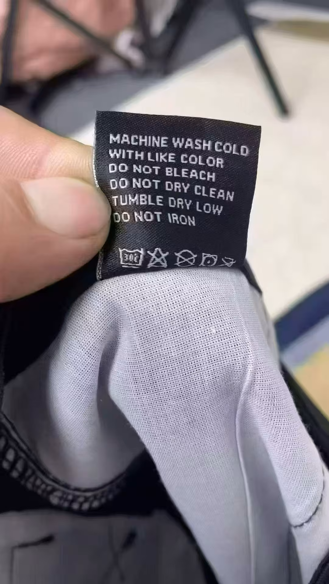 Garment laundering instructions and heavy cotton-blend stretch fabric care label sewn inside men's tactical shorts