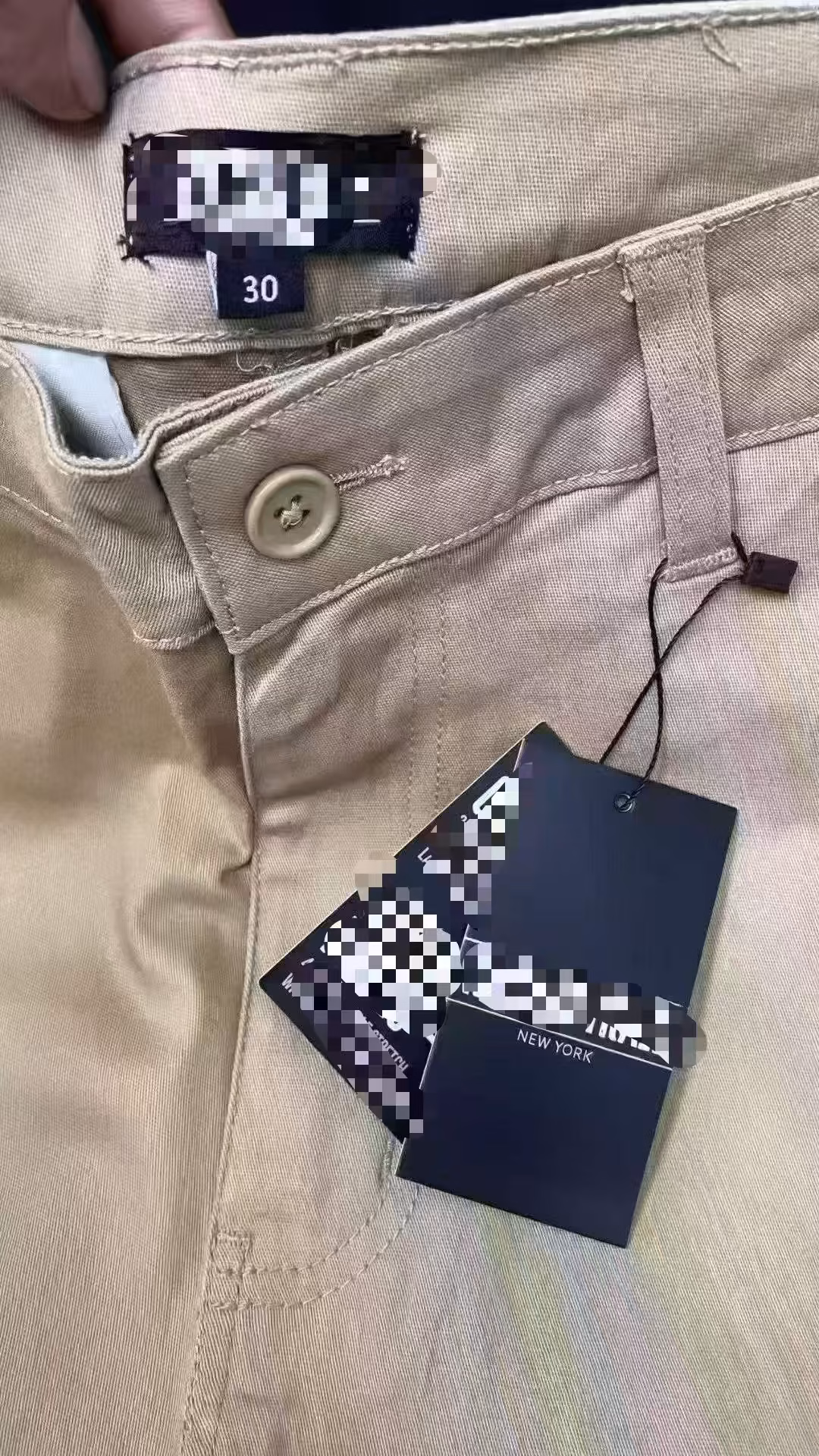Original factory clearance brand cardboard hangtags displaying stretch fabric technologies and barcode stickers on pristine cargo shorts