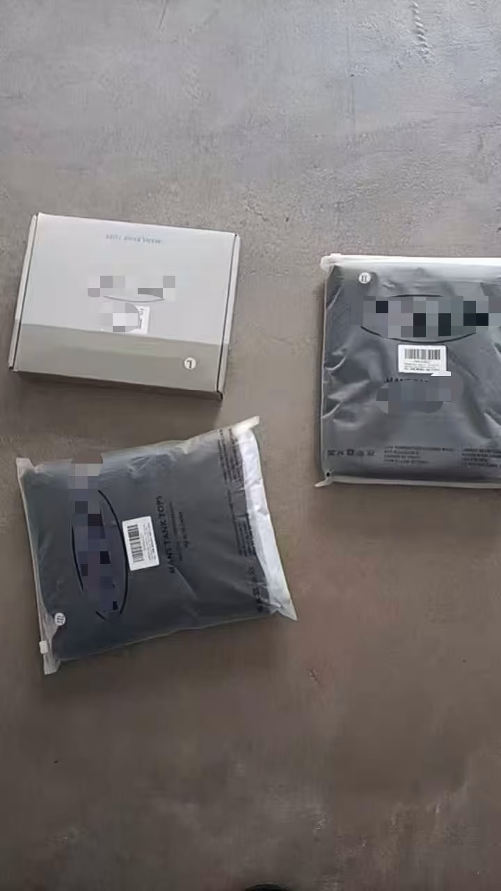 Pristine retail-ready presentation showing individual protective factory polybag enclosing a neatly folded sports tank top with printed size metrics