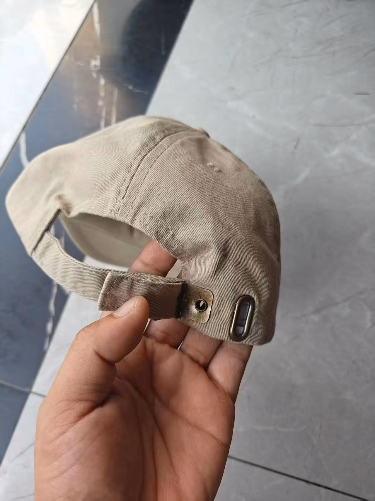 Back view of the washed cotton cap showcasing the heavy-duty adjustable metal buckle strapback closure for universal sizing