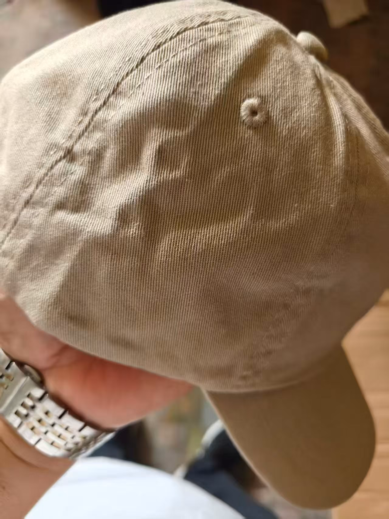 Detailed shot of the precision multi-row stitching on the curved brim and breathable embroidered eyelets of the dad hat
