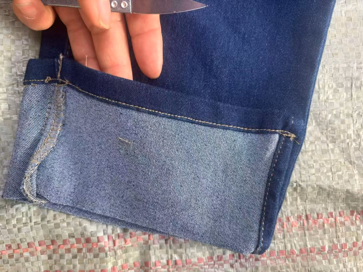 Close-up of flexible ribbed elastic denim waistband with contrast functional dark blue active drawstring