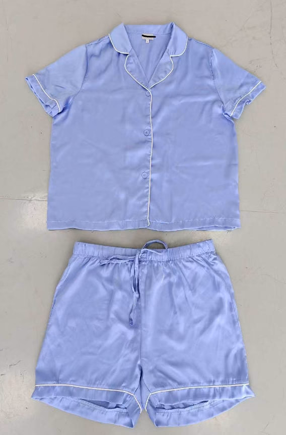 Front view of an elegant model wearing a women's dusty rose floral satin pajamas short sleeve 2-piece set