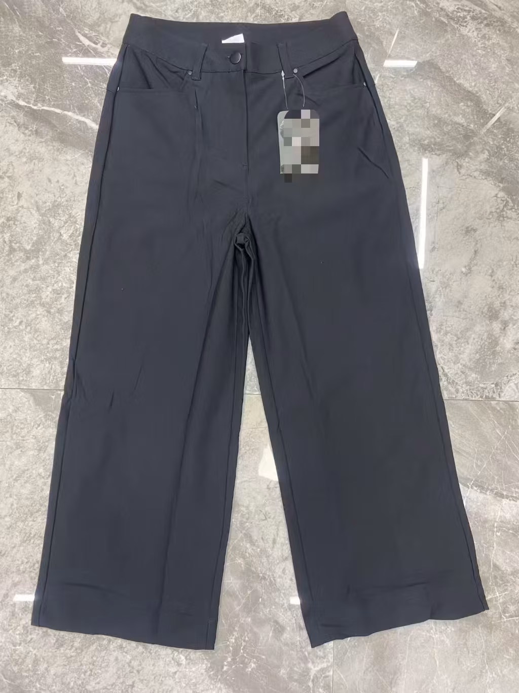 Front flat lay view of women's premium high-waisted wide-leg tailored trousers in dark obsidian colorway